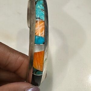 A Navaio sterling silver cuff bracelet with black onyx inlay signed Jim Royer